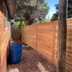 Cedar privacy fence installation with horizontal slat design by All Woods Tree Service in Northern Utah
