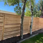 Cedar privacy fence installation with horizontal boards in Northern Utah - All Woods Tree Service