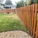 Stained wood picket fence installed by All Woods Tree Service in Northern Utah